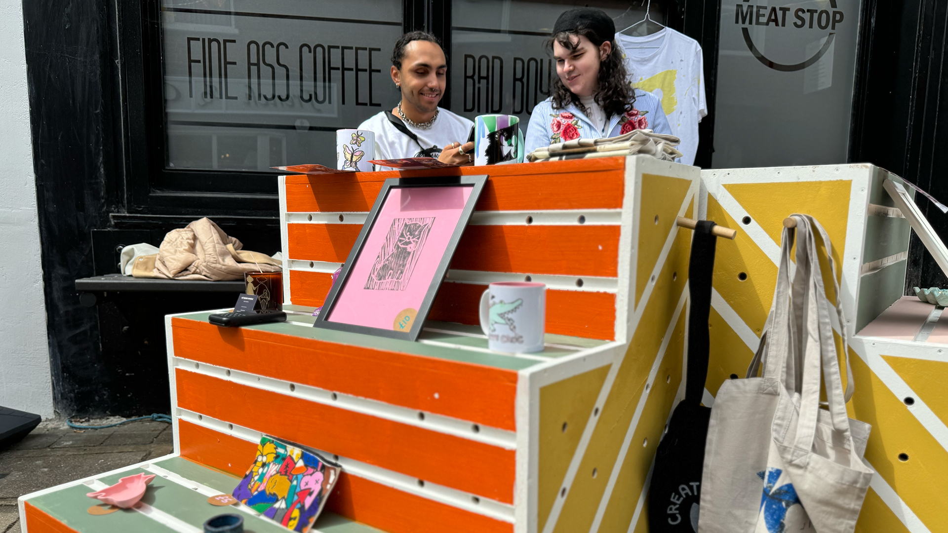 Two members of the Creative Cove's CC Collective outside the shop with the mobile retail unit